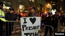 FILE - A supporter of President-elect Donald Trump shouts back at opposing demonstrators during a protest against the President-elect in New York, Nov. 11, 2016.