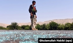 FILE - An Afghan soldier keeps watch during clashes with Islamic State militants in Kot district of Nangarhar province, Afghanistan, June 26, 2016.