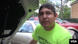 Omar Delfin says he and his wife and child will stay with relatives who live outside the flood zone to avoid exposure to health-threatening mildew and mold, which has already started growing in carpet and on walls in flooded apartments. (G. Flakus/VOA)
