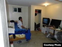 Guillermo Peralta sits in his basement apartment in York Springs, Pennsylvania. (Photo courtesy of Mike Kornely)
