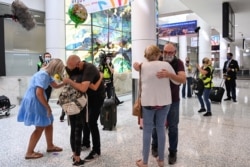 People reunite at Sydney Airport in the wake of COVID-19 border restrictions easing, with fully vaccinated Australians being allowed into Sydney from overseas without quarantine for the first time since March 2020, in Sydney, Australia, November 1, 2021.