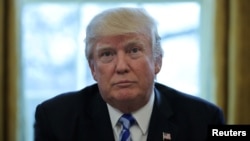 U.S. President Donald Trump talks to journalists at the Oval Office of the White House after the American Health Care Act was pulled before a vote in Washington, March 24, 2017.