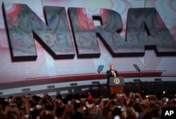 FILE - U.S. President Donald Trump speaks during the National Rifle Association-ILA Leadership Forum, April 28, 2017, in Atlanta, Georgia.