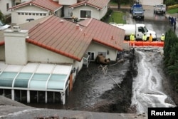 Crews work to channel mudflows in the area of the 2013 Springs Fire, in Camarillo, California, Dec. 2, 2014.