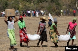 FILE - Villagers collect their monthly food aid provided by United Nations World Food Programme (WFP) in Bhayu, Zimbabwe, September 14, 2016.