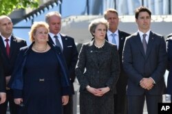 Norway's PM Erna Solberg, British PM Theresa May, Canadian PM Justin Trudeau, from left, look on as U.S. President Donald Trump speaks during ceremony at the NATO summit in Brussels on May 25, 2017.