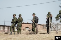 Lesotho soldiers stand close to a voting station during the country's general elections on June 3, 2017, in Maseru.