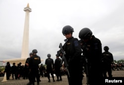Mobile brigade policemen attend a ceremony ahead of the Christmas and New Year celebrations in Jakarta, Indonesia, Dec. 21, 2017.