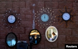 A vendor sells clocks and mirrors in Suto Orizari, a district with Europe's largest Roma communities, Macedonia, Dec. 2, 2016.