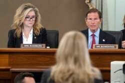 Sen. Marsha Blackburn, R-Tenn., left, and Sen. Richard Blumenthal, D-Conn., right speak to former Facebook data scientist Frances Haugen, center, during a hearing on Capitol Hill, Oct. 5, 2021.