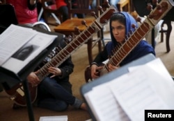FILE - Members of the Zohra orchestra, an ensemble of 35 women, rehearse at Afghanistan's National Institute of Music, in Kabul, April 4, 2016.