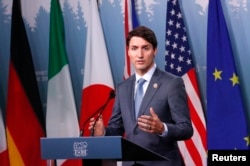 Canada's Prime Minister Justin Trudeau listens while addressing the final news conference of the G-7 summit in the Charlevoix city of La Malbaie, Quebec, June 9, 2018.