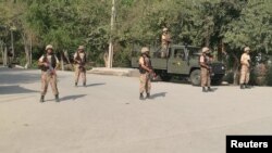 FILE - Pakistani Army soldiers stand guard at a street after suicide bombers attacked a Christian neighborhood in Khyber Agency near Peshawar, Pakistan, Sept. 2, 2016. Some security and political analysts say measures taken by the government against militants are commendable, but add that more needs to be done.