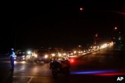 Residents flee as new evacuation orders are issued, Oct. 14, 2017, in Santa Rosa, Calif. The death toll after a week of blazes in the state rose to at least 35, with at least 16 fires burning.