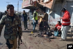 Pakistani police officers and rescue workers gather at the site of suicide bombing in Quetta, Pakistan, Jan. 13, 2016.