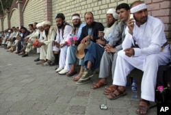 FILE - Participants of the Helmand peace march, who trekked across the country on foot calling for an end to the war, arrive in Kabul, Afghanistan, June 18, 2018.