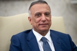 FILE - Iraqi Prime Minister Mustafa al-Kadhimi attends a meeting in Washington, July 26, 2021.