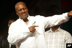 Ghana Incumbent President, John Dramani Mahama candidate of the National Democratic Congress gestures to his supporters during a presidential election rally at Accra Sports Stadium in Accra, Ghana, Dec. 5, 2016.