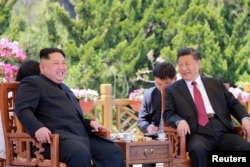 North Korean leader Kim Jong Un meets with China's President Xi Jinping, in Dalian, China in this undated photo released on May 9, 2018 by North Korea's Korean Central News Agency (KCNA).