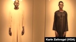 Two cattle herders from the Lakes state village of Yirol who posed for American photographer Tim Freccia and feature in Freccia's "Life and Death" exhibit.