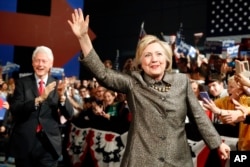Democratic presidential candidate Hillary Clinton and Former President Bill Clinton move to the stage at her presidential primary election night rally, April 26, 2016, in Philadelphia.