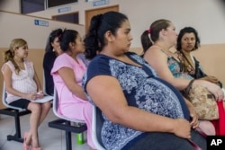 FILE - Women wait their turn for their pre-natal exams at the National Hospital for Women in San Salvador, El Salvador, Jan. 29, 2016.