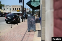 A chalkboard pointing to a FEMA office is shown in the aftermath of Tropical Storm Harvey in Wharton, Texas, Sept. 6, 2017.