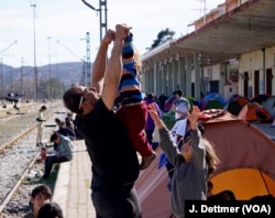 A Syrian father plays with his son.