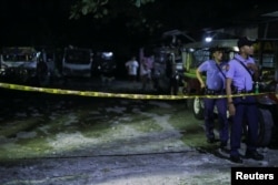Police officers stand behind a police line after a man was killed during a police anti-drug operation in Caloocan city, Metro Manila, Philippines, Aug. 17, 2017.