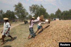 FILE - Construction workers stack stones on the island of Bhasan Char in the Bay of Bengal, Bangladesh, Feb. 14, 2018.
