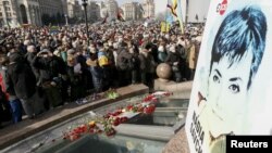 FILE- People take part in a rally in central Kyiv, Ukraine, demanding the release from a Russian prison of Ukrainian army pilot Nadiya Savchenko, March 6, 2016.