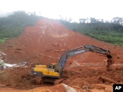 Heavy equipment is used as rescue workers search for survivors and victims following a mudslide in Regent, east of Freetown, Sierra Leone, Aug. 14, 2017.