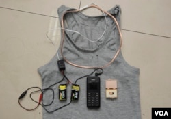 A hidden coil in a shirt, two batteries, a mobile phone and a receiver were found on a student and confiscated by the authorities as cheating equipment for a Chinese test in Chengdu, Sichuan province in 2014. (REUTERS)