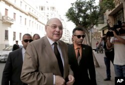 FILE - Egyptian presidential candidate Moussa Mustafa Moussa, center left, arrives in front of his campaign headquarters in downtown in Cairo, March 4, 2018.