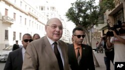FILE - Egyptian presidential candidate Moussa Mustafa Moussa, center left, arrives in front of his campaign headquarters in downtown in Cairo, March 4, 2018.