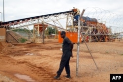FILE - A security employee guards a diamond-processing plant in the diamond-rich eastern Marange region of Zimbabwe, Dec. 14, 2011.