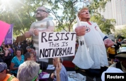Protesters gather outside a Donald Trump campaign rally in Phoenix, Ariz., Aug. 22, 2017.
