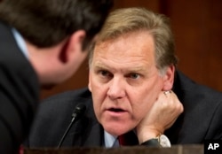 FILE - Then-House Intelligence Committee Chairman Mike Rogers, R-Mich., confers with a fellow committee member on Capitol Hill, April 2, 2014.