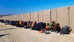 This photo provided by the Kurdish-led Syrian Democratic Forces shows some Islamic State group fighters, who were arrested by the Kurdish-led Syrian Democratic Forces after they attacked Gweiran Prison, in Hassakeh, northeast Syria, Jan. 21, 2022.