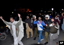 FILE - Pakistani police officers, in helmets, arrest protesters at a demonstration against the acquittal of Asia Bibi, a Pakistani Christian woman who was facing blasphemy charges, in Lahore, Pakistan, Jan. 29, 2019.