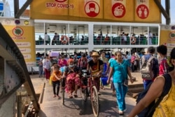 FILE - People disembark from a ferry at the Pansodan jetty in Yangon, Myanmar on Nov. 12, 2021.