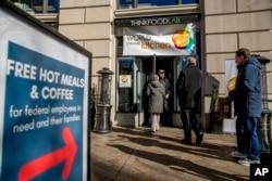 Trabajadores federales de EE.UU. con licencia obligada por el cierre parcial del gobierno hacen fila para recibir alimentos y suministros del World Central Kitchen, una organización caritativa iniciada por el chef español-estadounidense José Andrés en Washington, D.C.. Martes 22 de enero de 2019.