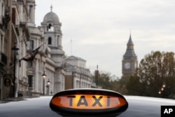 A taxi sign is lit up on a vehicle in London, Nov. 8, 2016.