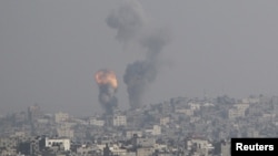 An explosion and smoke are seen after an Israeli strike in Gaza November 15