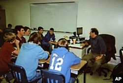 Teacher Michael Bair emphasizes teamwork, reading, writing, computer skills and public speaking in his 9th grade English class for boys.