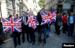 FILE - Vote Leave supporters wave Union flags, following the result of the EU referendum, outside Downing Street in London, Britain June 24, 2016.