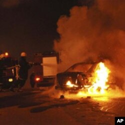 Egyptian firemen try to put out a fire on a vehicle following a car bombing in front of a Coptic Christian church in the Egyptian city of Alexandria, 01 Jan 2011
