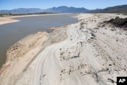 FILE - The Theewaterskloof Dam, a key source of water supply to Cape Town, South Africa, is shown at low levels, April 16, 2017.