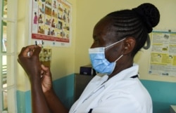 Pamela Omboko, a nurse, prepares a vaccine against malaria for infants at the Yala Sub County Hospital Mother and Child Healthcare (MCH) clinic in Gem, Siaya County, Kenya, October 7, 2021.