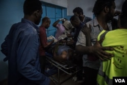 Medical staff attend to a man suffering convulsions from tear gas inhalation at a clinic in the sit-in in Khartoum on the night of May 13 2019. (J. Patinkin for VOA)